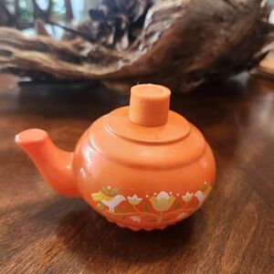 vintage 1970s Avon orange teapot-shaped decanter or bottle
